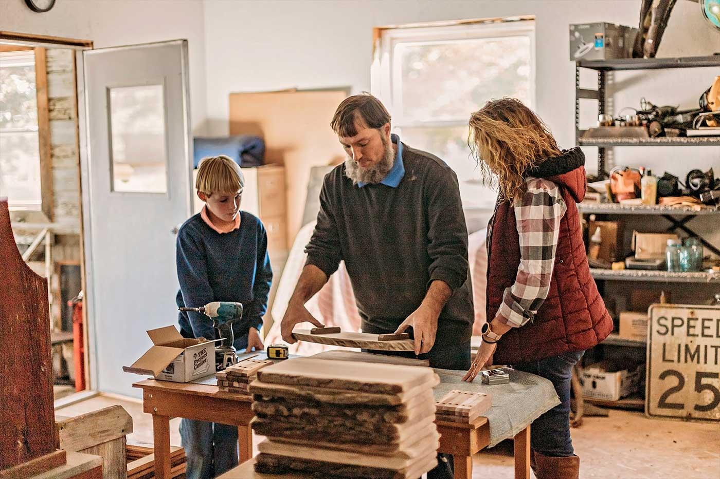 Amish man demonstrating woodworking to a female tourist