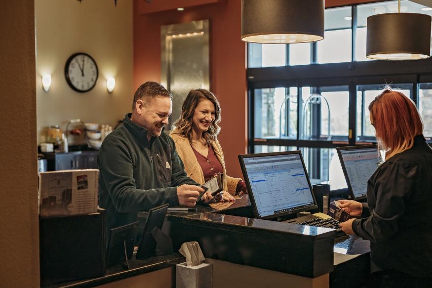 Couple checking into hotel